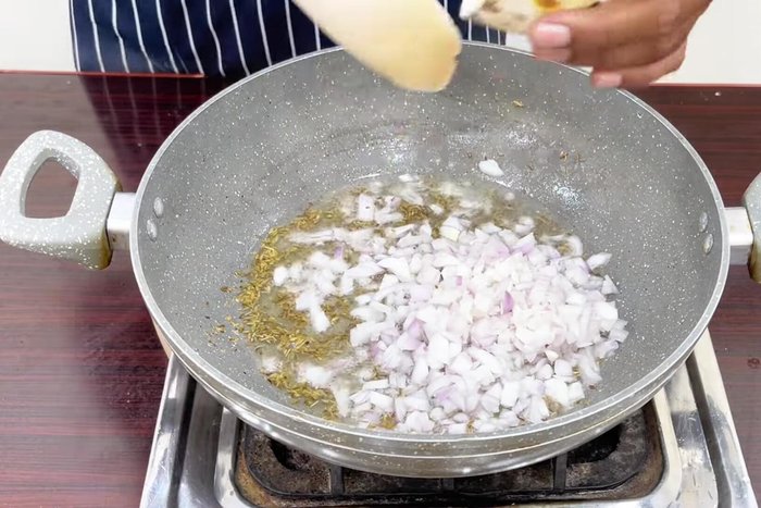 Add chopped onions and sauté until lightly browned.