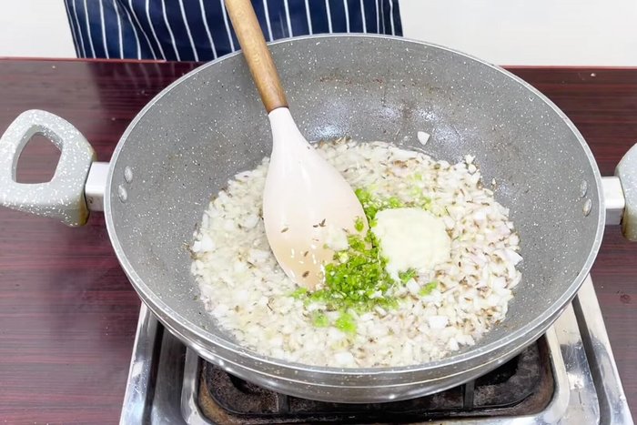 Add green chilies and garlic-ginger paste. Fry for a minute.