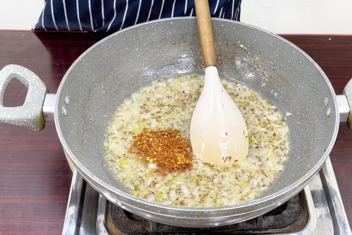 Add crushed red chili, Kashmiri chili powder (optional), salt, turmeric powder, and sauté for 2-3 minutes.