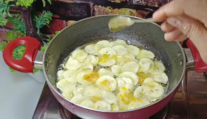 Add the salt-turmeric water to the partially cooked banana slices. Stir well.