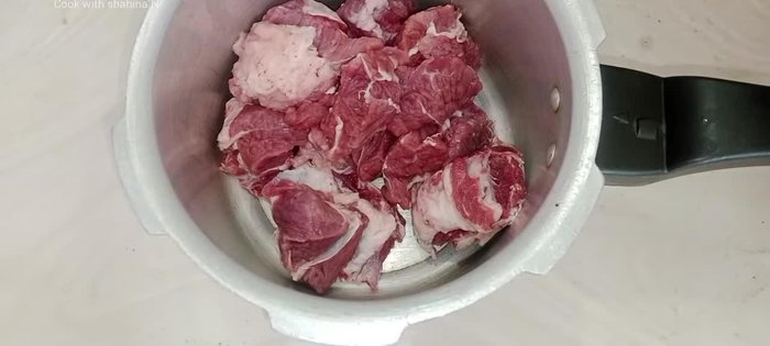 In a pot, combine buffalo meat, fat, onion, garlic cloves, red chilies, fennel, and salt. Add water and oil. Stir, cover, and cook on high heat for 5 minutes, then lower heat.