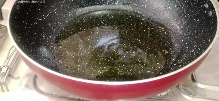 In a separate pan, heat oil and fry onions until golden brown. Set aside half of the fried onions.