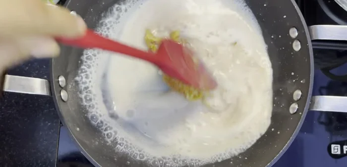 When the sugar is completely melted, add 1 cup of cold milk. Stir continuously as the sugar will initially solidify, but will melt as the milk heats up.