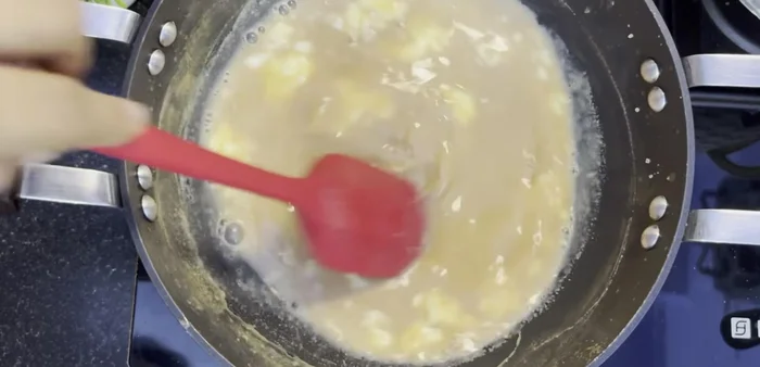 Add 2 tbsp of cream (use less if using full-fat milk), 2 tbsp milk powder, and 1/4 tsp cardamom powder. Mix well.