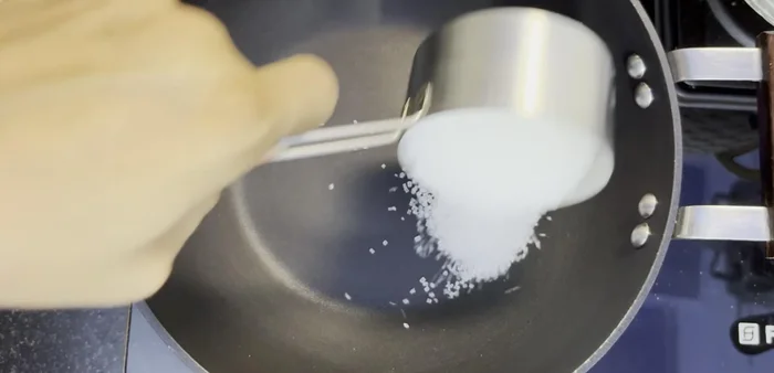 Place a pan on the gas. Add 1/2 cup sugar and spread it evenly. Caramelize the sugar on medium-high heat without adding any water or milk.