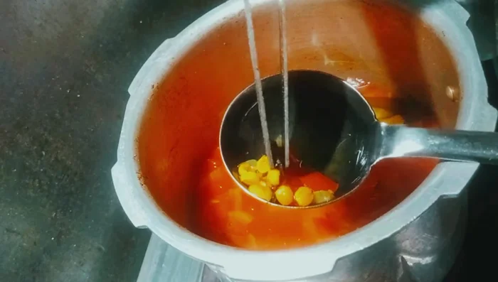 Remove whole spices from the cooked dal.