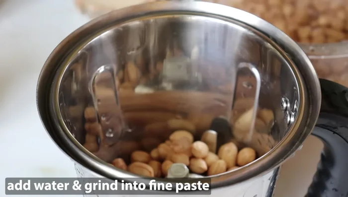 Drain the water and grind the soaked peanuts into a smooth paste using a mixer. Add water as needed to achieve a thin paste consistency.