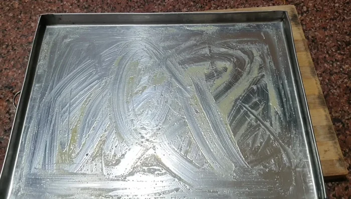 Pour the mixture onto a greased baking tray lined with parchment paper. Spread evenly.