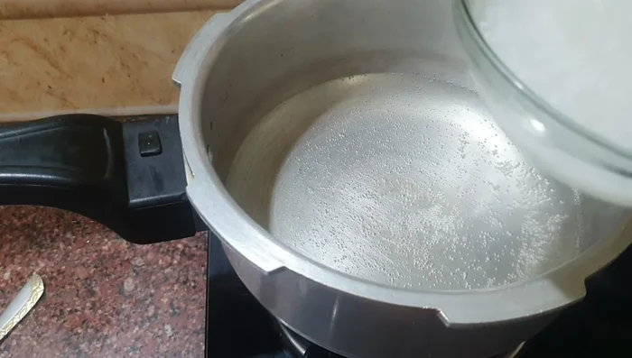 Cook the soaked rice in a cooker with 3 cups of water for one whistle.