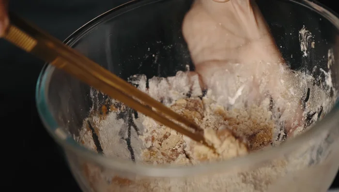 Deep fry the chicken at 350°F for about 10 minutes until cooked through and crispy.