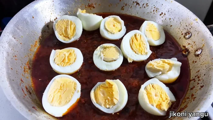 Add boiled eggs gently, ensuring they are coated in the sauce.
