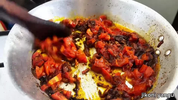 Mash the tomatoes.