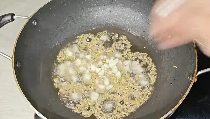 In a pan, heat oil and temper with fennel seeds, garlic, asafoetida, dried red chilies, and curry leaves. Gently sauté until fragrant.