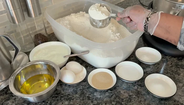 Warm the milk slightly. In a mixer, combine the warmed milk, yogurt, oil, eggs, yeast, salt, sugar, and baking soda.