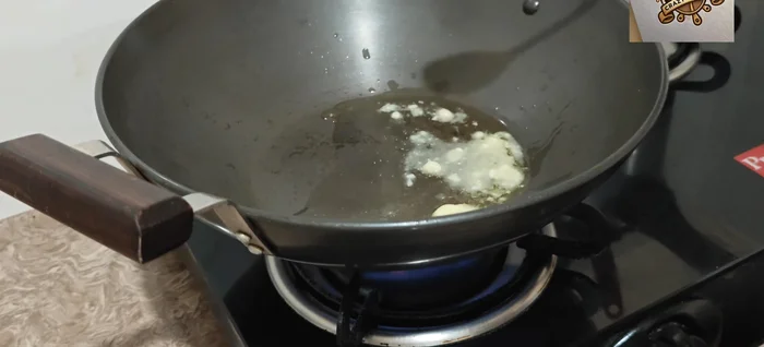 Sauté aromatics: Heat ghee in a pan. Add nigella seeds, then ginger-garlic paste. Stir well and reduce the flame.
