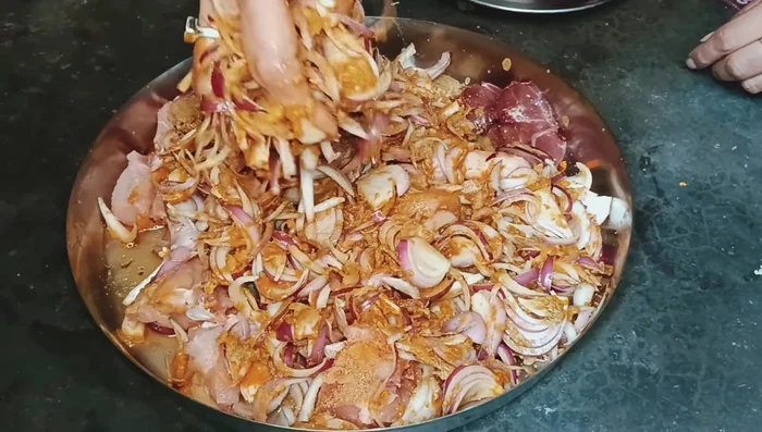 Add the marinated chicken to the pan and mix thoroughly. Ensure the chicken and masala are well combined.