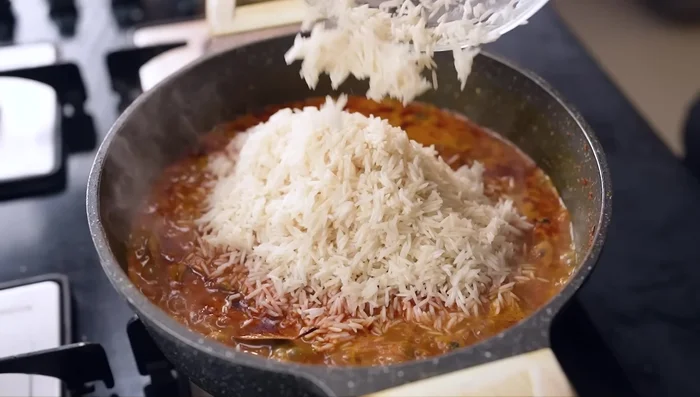 Add the rice and stir gently. Add salt, chopped coriander, and mint.