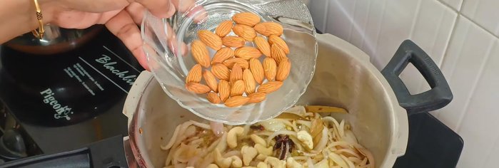 Add cashews and almonds; roast slightly.