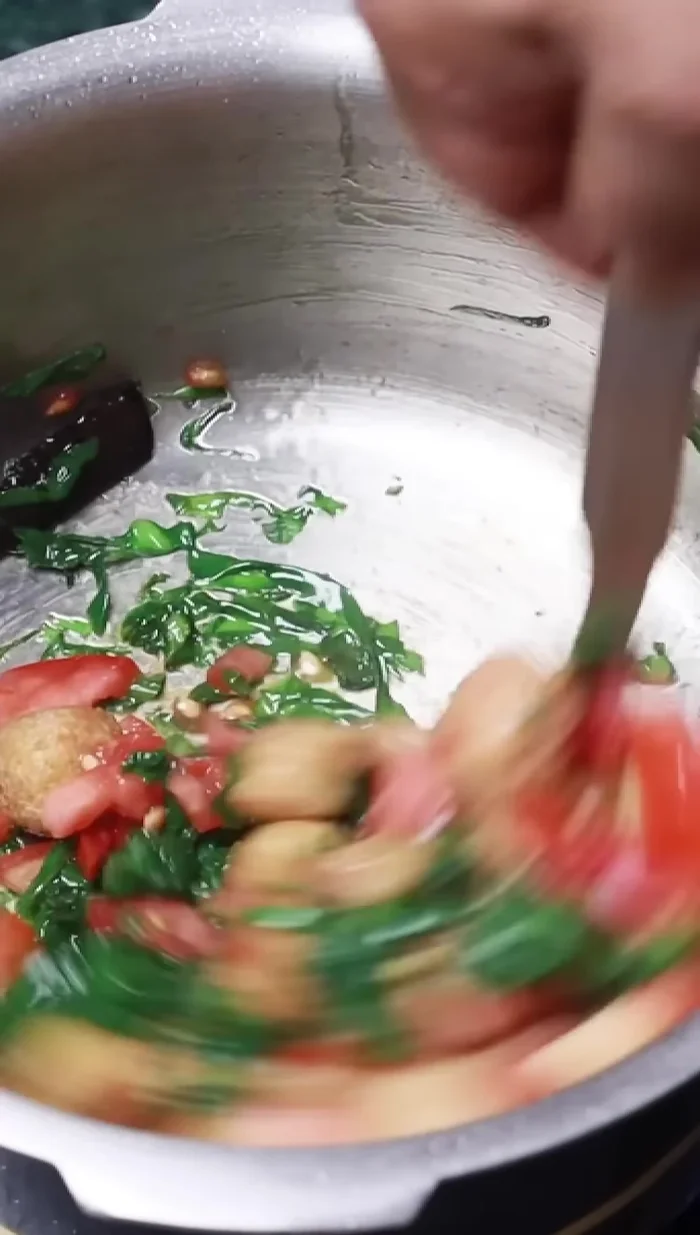 Add tomatoes and mix. Add dal, turmeric, salt, asafoetida, and crushed red chili.