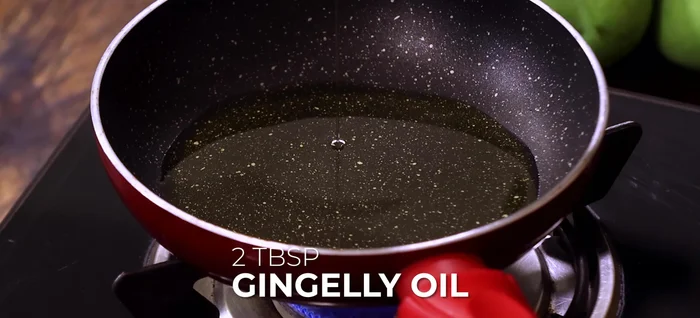 Make tempering: In a small pan, heat gingerly oil. Add chana dal, urad dal, mustard seeds, cumin seeds, crushed garlic cloves, and roast until golden. Turn off heat, add broken red chilies, asafoetida powder, and curry leaves.