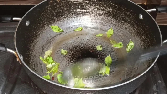 Add curry leaves and fry until they crackle.