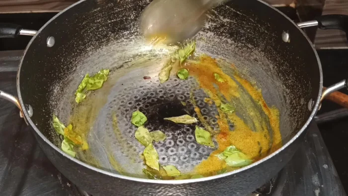 Add 1/2 tsp turmeric powder and fry well to avoid a strong turmeric taste and achieve a nice yellow color.