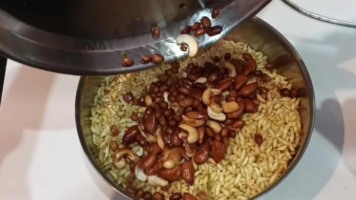 Remove the puffed rice and add the fried dry fruits.