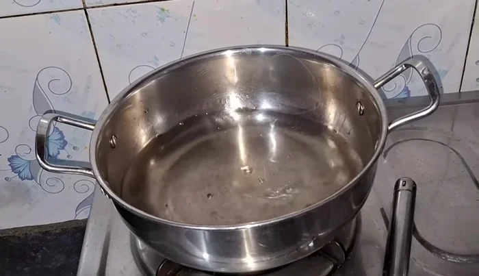 Boil ½ litre of water in a pan. Place a deep plate on top of the pan to create a double boiler.