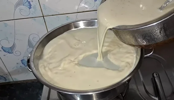 Pour the prepared milk mixture into the deep plate set over the boiling water.