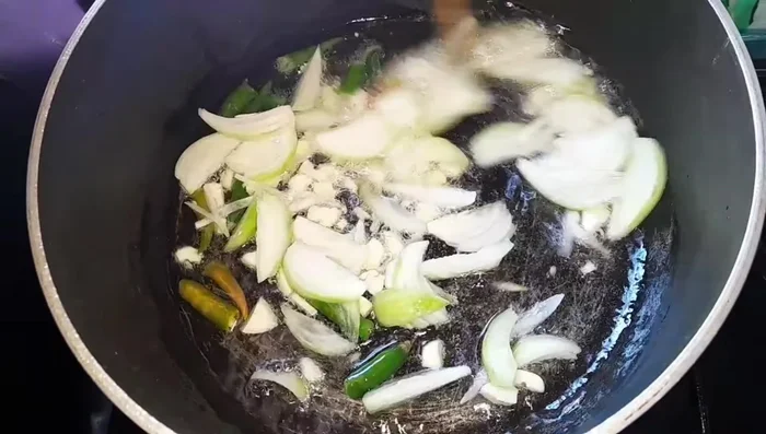 Add the chopped spinach herbs to the pan and stir.