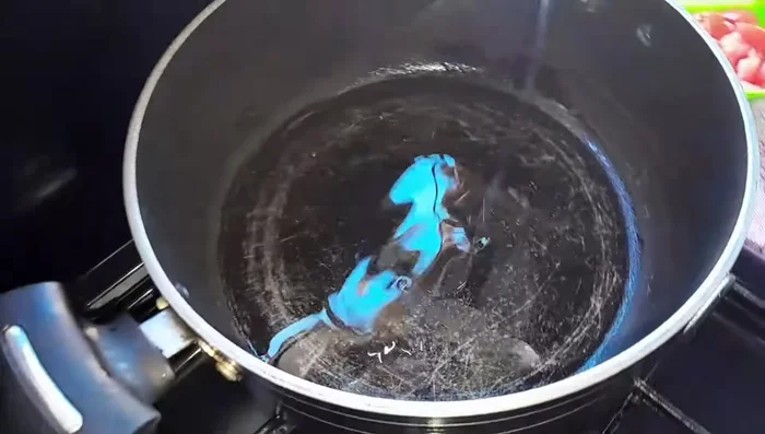 Heat oil in a pan. Add the chilies (green and ripe), garlic, and onions. Fry until fragrant.