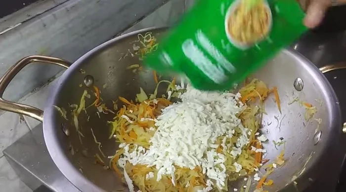 Remove half of the cooked vegetables. Add paneer, oregano, chilli flakes, marinade powder, chaat masala, and green coriander to the remaining vegetables. Mix well. This is your stuffing.