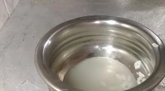 Drain excess water from soaked poha.