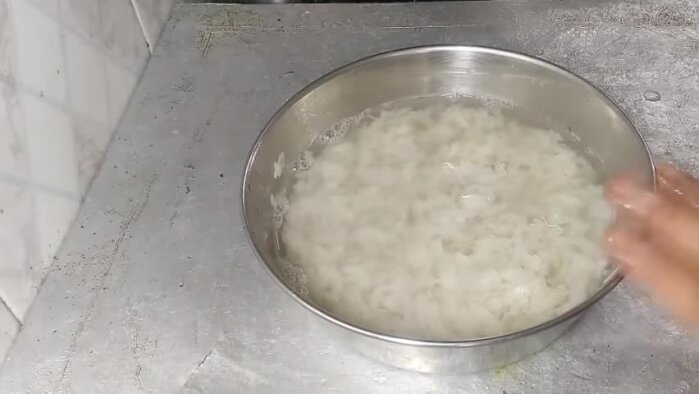 Wash poha and add hot water, let it sit.