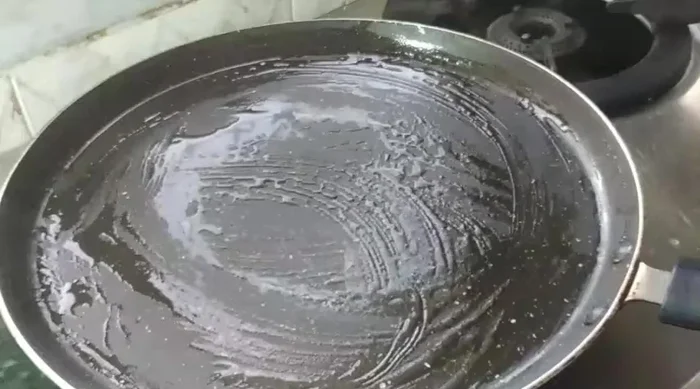 Heat a greased pan. Pour spoonfuls of batter, spread thinly, and cook on low flame until cooked through and dry on top.