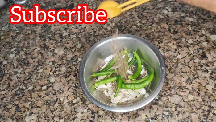 Grind the garlic, green chilies, cumin seeds, salt, and green coriander into a coarse paste. Add minimal water only to aid blending.