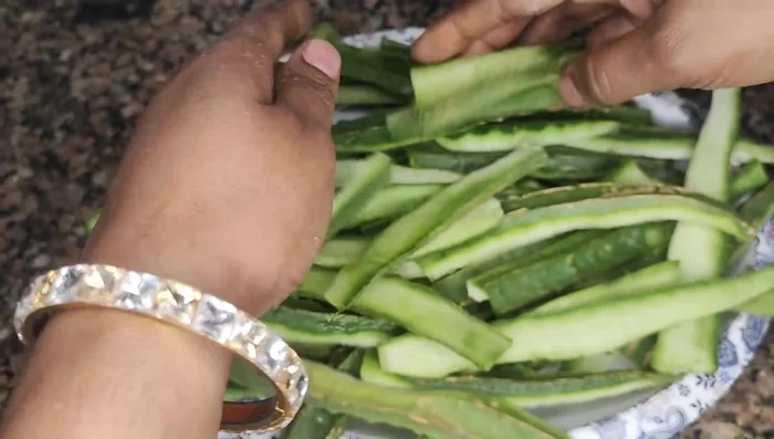 Peel the ridge gourds and cut the peels into smaller pieces.