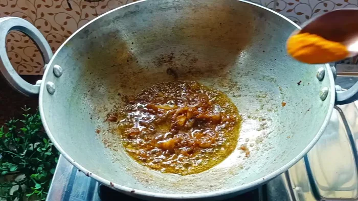 Add ginger-garlic paste (1.5 tablespoons), 0.5 teaspoon turmeric powder, 1 teaspoon cumin powder, 1 teaspoon coriander powder, and 0.5 teaspoon chili powder. Fry until the oil separates (8-10 minutes), adding a little water if it sticks.