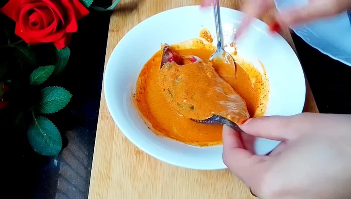 Coat the fish evenly with the masala paste, ensuring the spices get into the cuts.