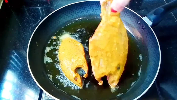 Heat oil in a frying pan over medium heat. Fry the fish pieces one by one, ensuring not to overcrowd the pan.