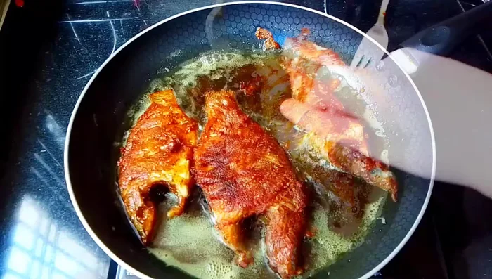 Remove the fish from the pan and place on a plate to drain excess oil.