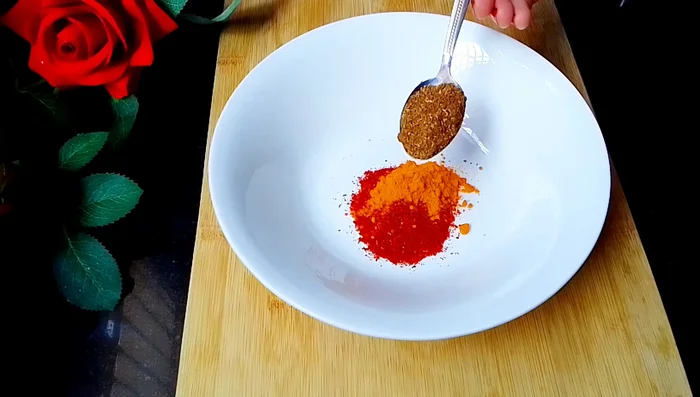 In a bowl, prepare the masala by mixing red chili powder, turmeric powder, garam masala powder, cumin powder, dry mango powder, salt, cornflour, and curd.