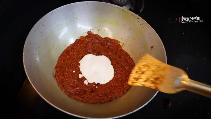 Reduce heat, add 3-4 spoons of sour curd, mixing immediately. Add 1 teaspoon of sugar.