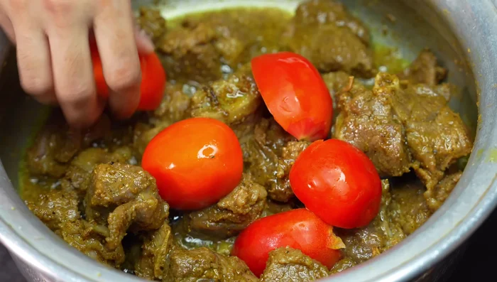 Add tomatoes (cut into halves) and cook covered on low flame for 5-6 minutes until softened. Remove tomato skins and mash the tomatoes well.