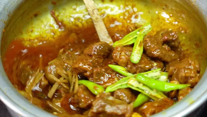 Add slit green chilies and julienned ginger. Cook for 1 minute and remove from heat. Let it rest for 10 minutes covered.