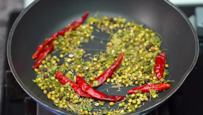 Add Kasuri Methi, let it cool. Grind the roasted spices into a coarse powder.