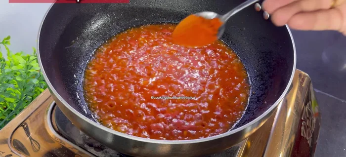 Add salt, red chili powder, crushed red chilies, turmeric powder, and cumin powder. Fry well to remove the raw flavor.