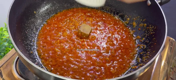 Add chicken cube (optional), 1/4 cup water, and cook until fragrant.