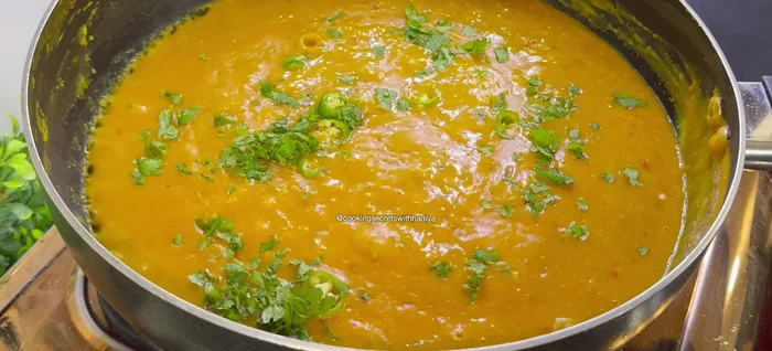 Garnish with green chilies, coriander leaves, and garam masala powder.