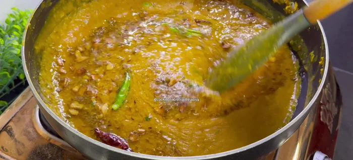 Pour the hot tadka over the dal and mix gently.